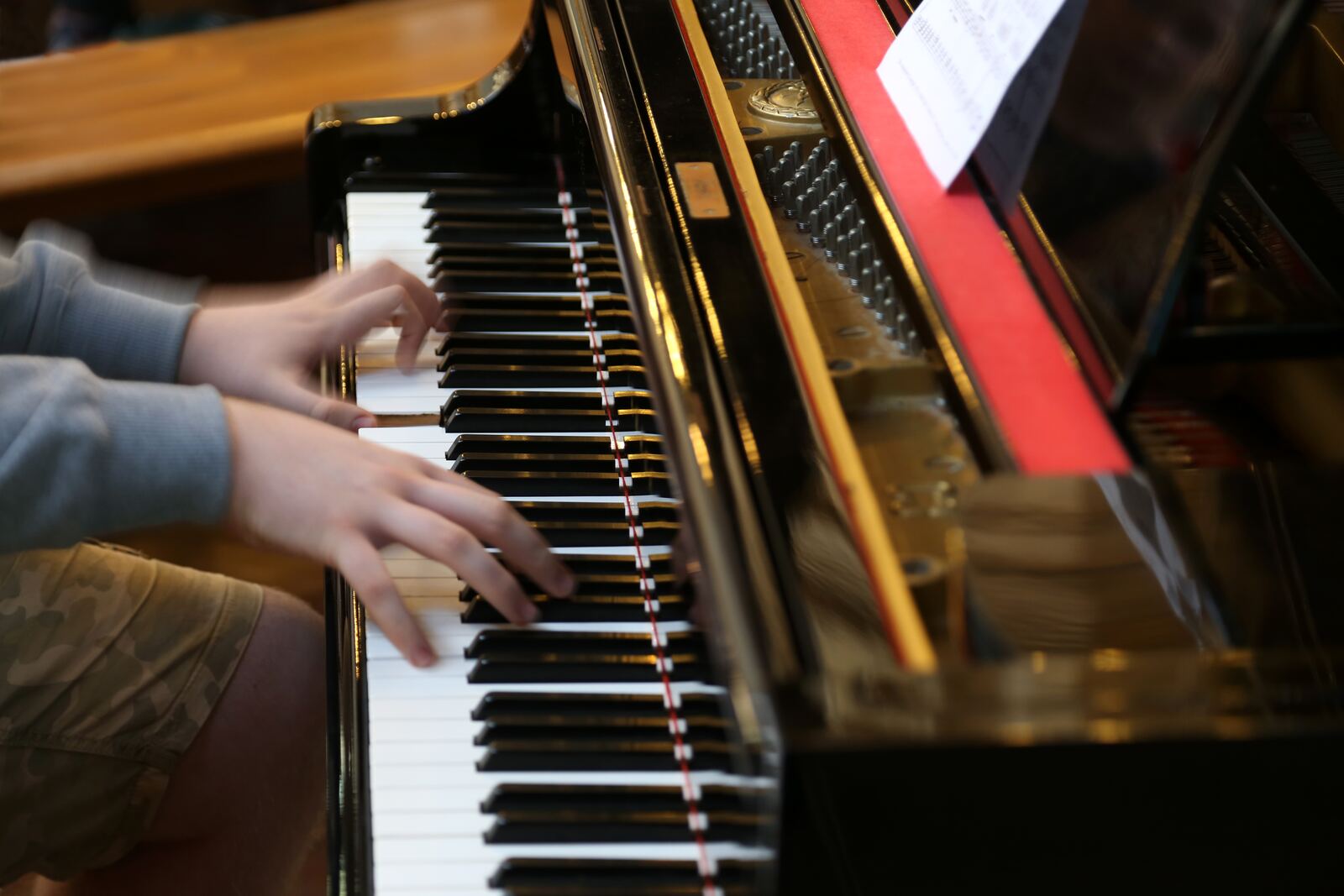 A child's hands playing the piano